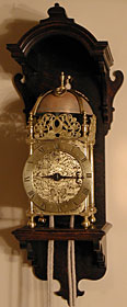 Unsigned Charles II period lantern clock (1660s) on a modern oak hooded bracket